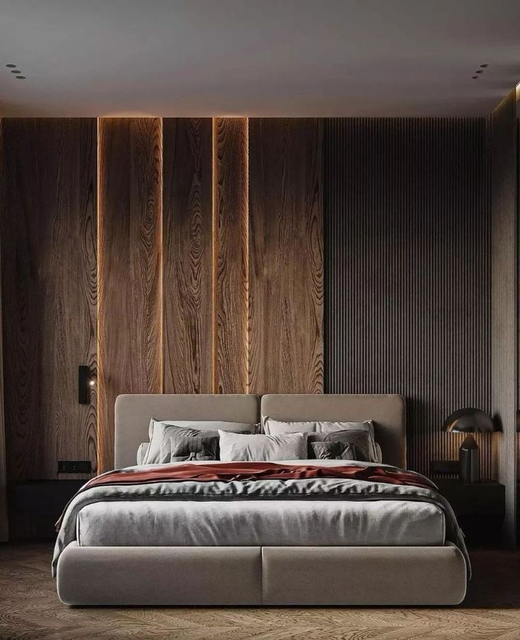 a large bed sitting in the middle of a bedroom next to a wall with wooden paneling