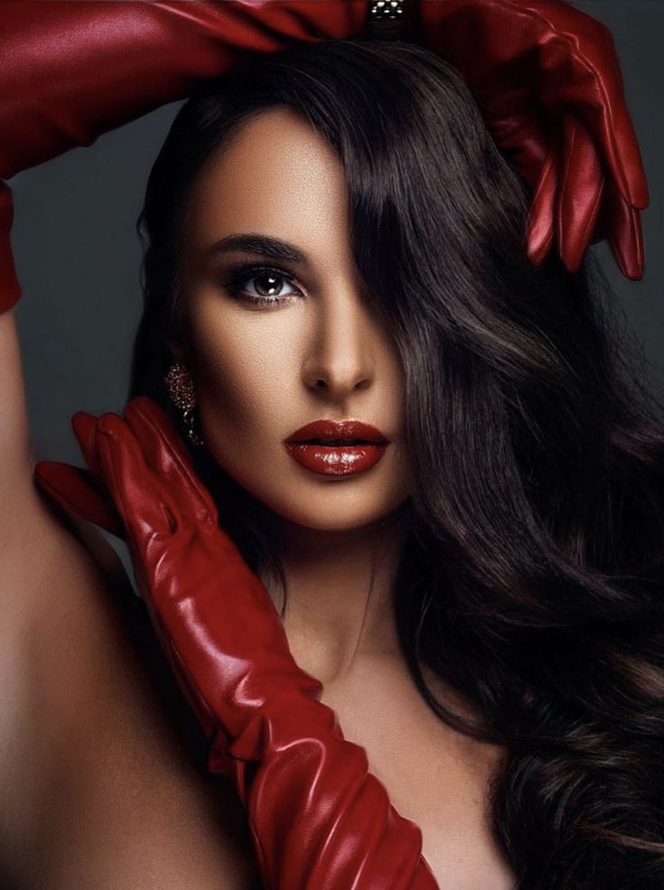 a woman with long hair wearing red gloves