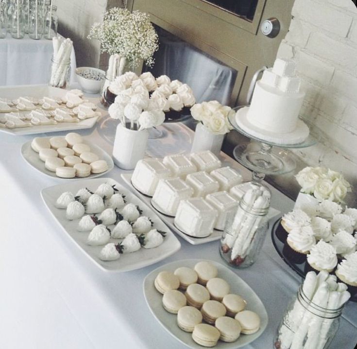 there are many desserts on the table ready to be eaten at this wedding reception