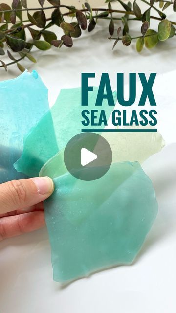 someone is holding some sea glass in front of a plant with the words faux sea glass on it