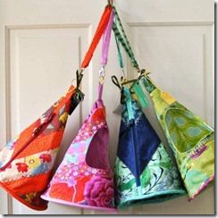 four colorful bags hanging from the side of a door