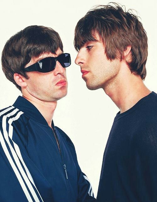 two young men wearing sunglasses are facing each other