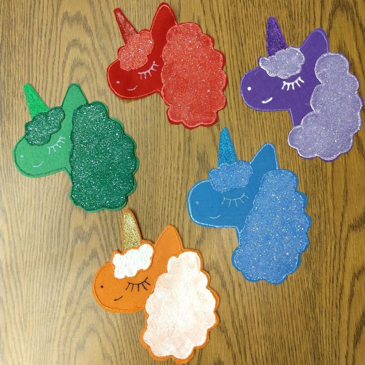 there are five felt animals on the table