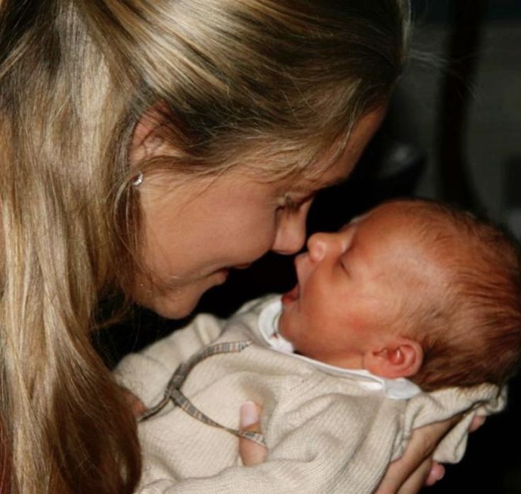 a woman holding a baby in her arms