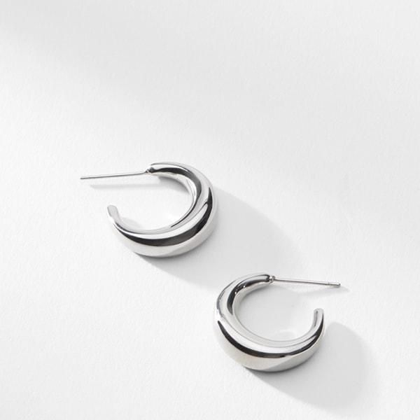 These crescent-moon-inspired earrings are just shiny enough to catch the light, but subtle enough to wear every day. Made from stainless steel. Modern Semi-circle Earrings For Everyday, Modern Crescent Jewelry For Pierced Ears, Minimalist Metal Earrings With Shiny Finish, Modern Semi-circle Earrings For Everyday Wear, Modern Crescent Earrings, Everyday Stainless Steel Earrings With Polished Finish, Elegant Half Moon Metal Earrings, Everyday Crescent Metal Earrings, Everyday Metal Crescent Earrings