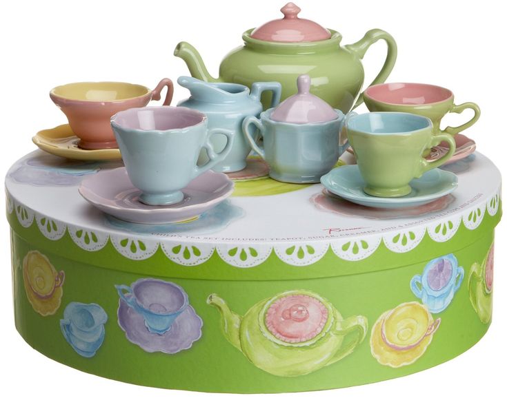 there are many cups and saucers on top of the table with teapots