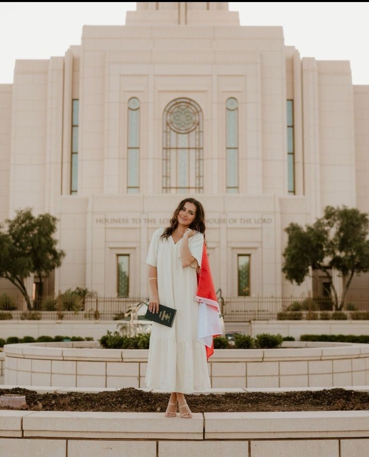 a woman standing in front of a large building