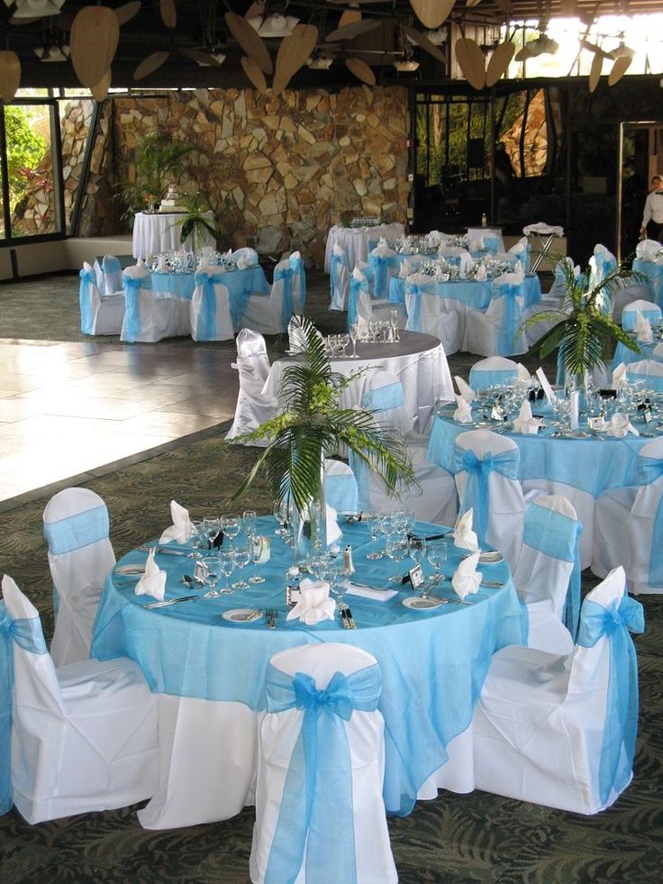 the tables are decorated with blue and white linens