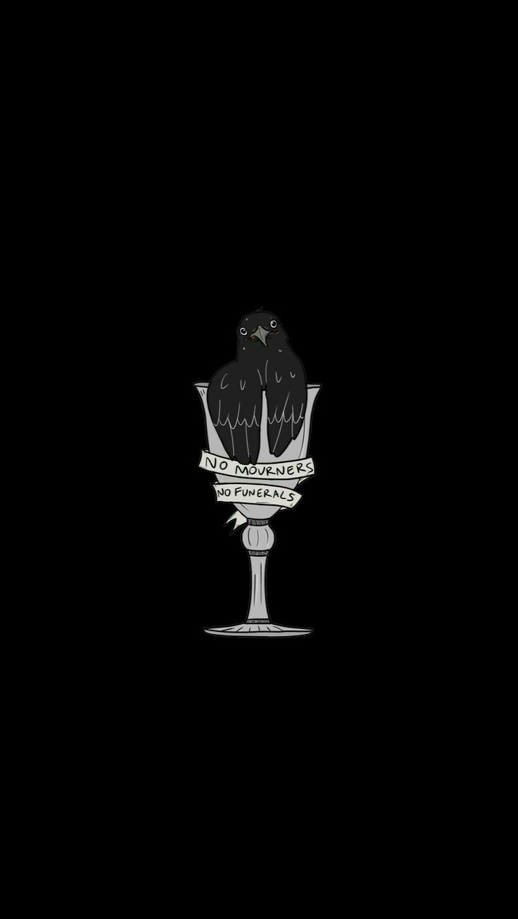 a black bird sitting on top of a glass vase in the middle of the night