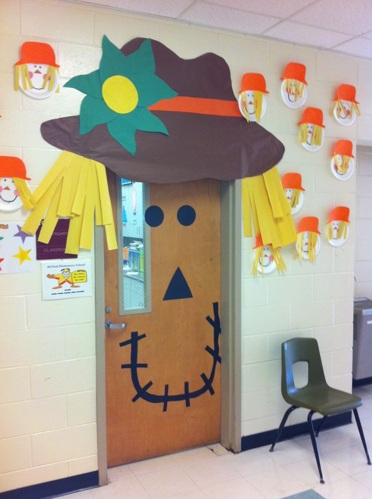 a classroom door decorated to look like a scarecrow with a hat on it's head