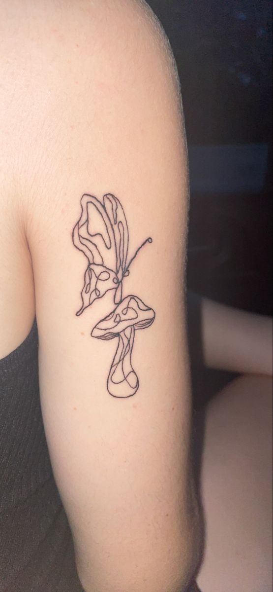 a woman's arm with a tattoo on it that has a flower in the middle