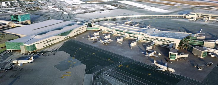 an aerial view of the airport with planes parked on the tarmac and buildings in the background