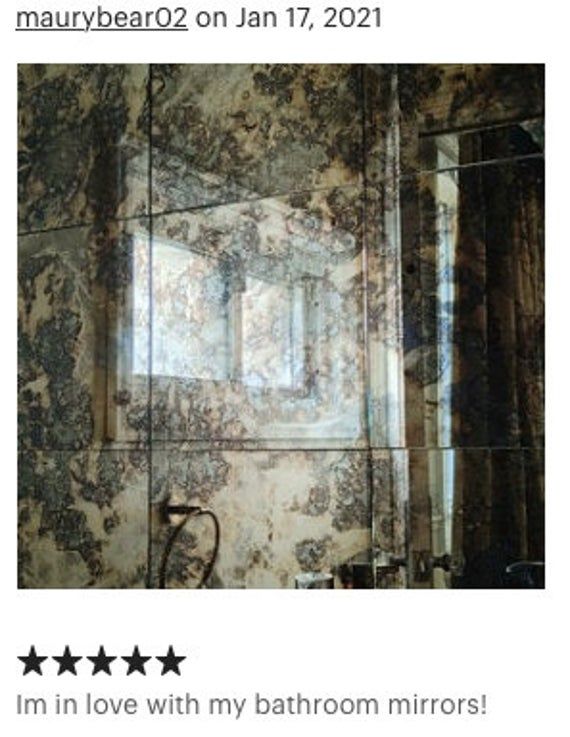 the bathroom mirror has been decorated with black and white marble, but it is not in use