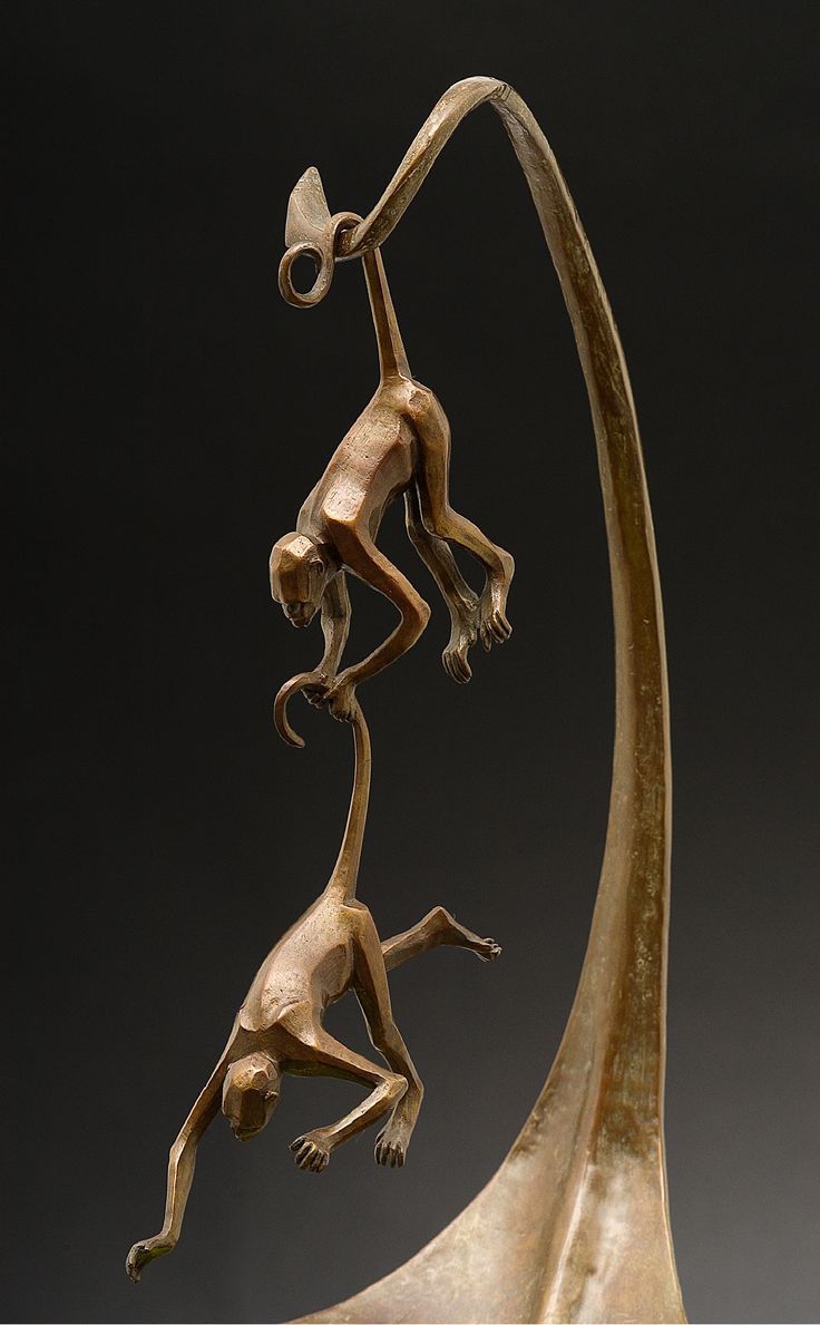 a bronze sculpture with two monkeys on it's back