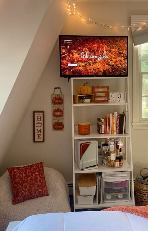 a bed room with a neatly made bed and a flat screen tv mounted to the wall