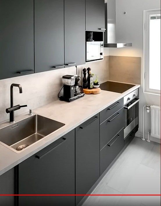 a kitchen with gray cabinets and white counter tops