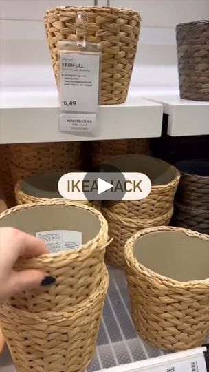 a person is pointing at some baskets on the shelf