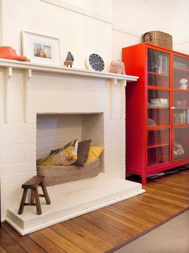 a fire place in the middle of a room with bookshelves on either side