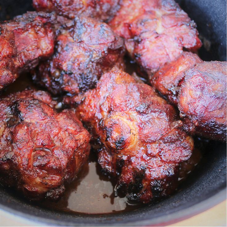 some meat is cooking in a pan on the stove top and it looks like they have been cooked