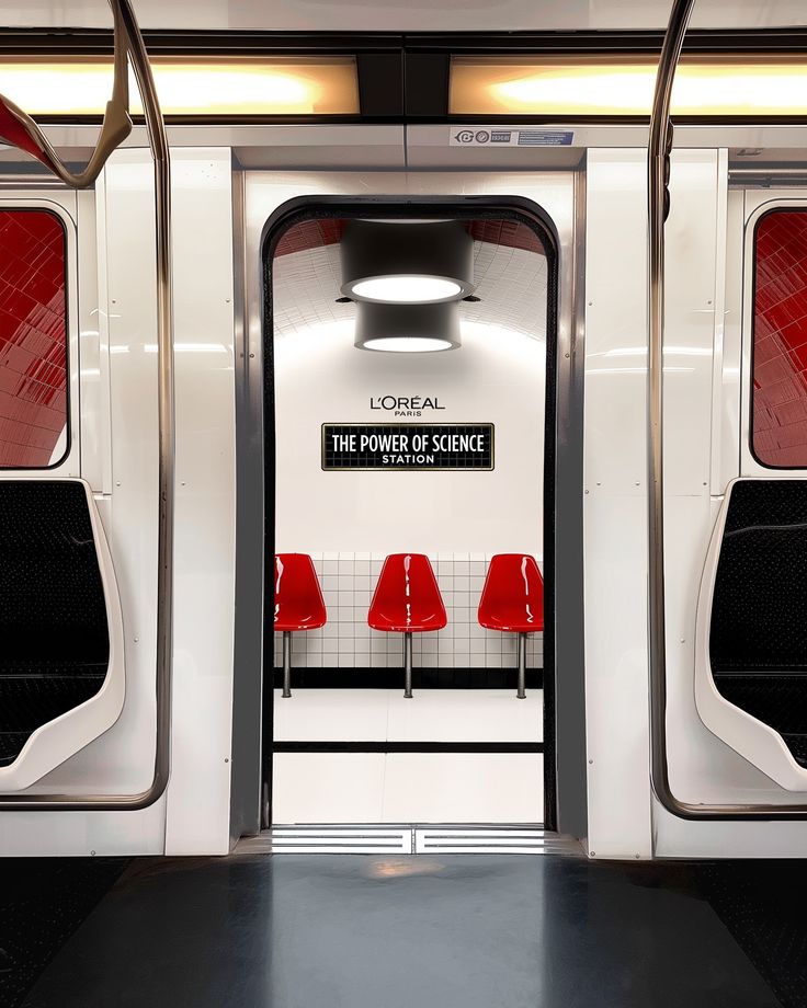 an empty subway car with red seats and the doors open to let people know where they are going