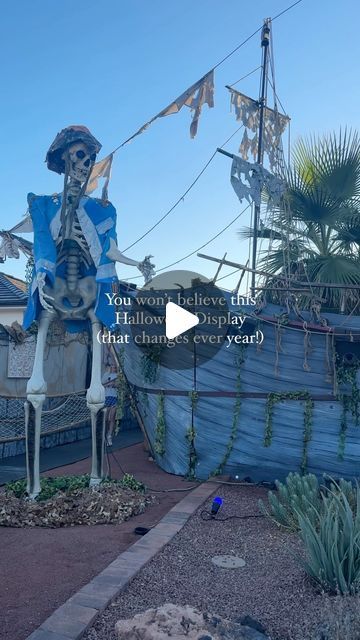 a fake skeleton in front of a pirate ship