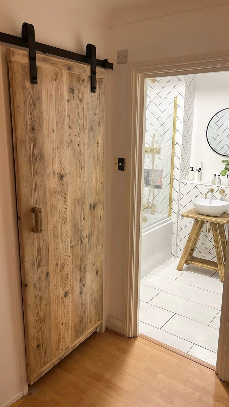 an open door leading to a bathroom with wooden floors