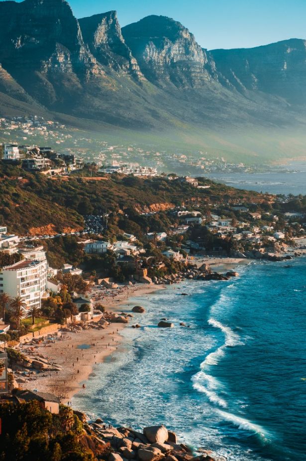 an aerial view of the beach and mountains in cape town, with houses on either side