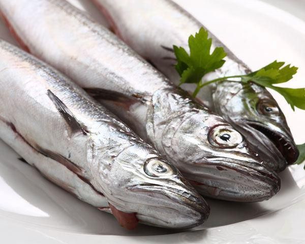 three fish are sitting on a plate with parsley