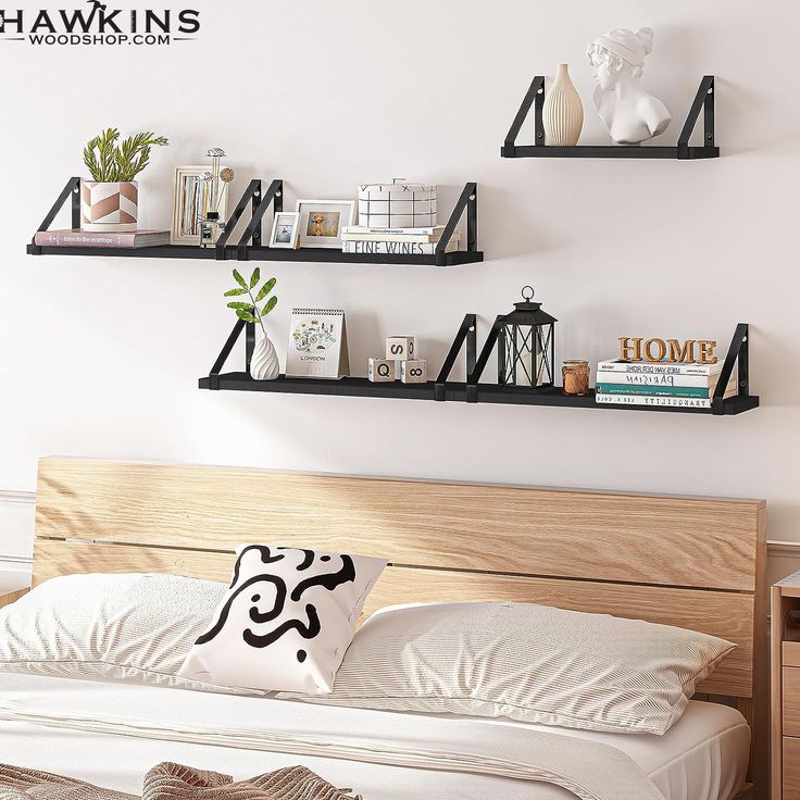 two shelves on the wall above a bed with pillows and bookshelves over it