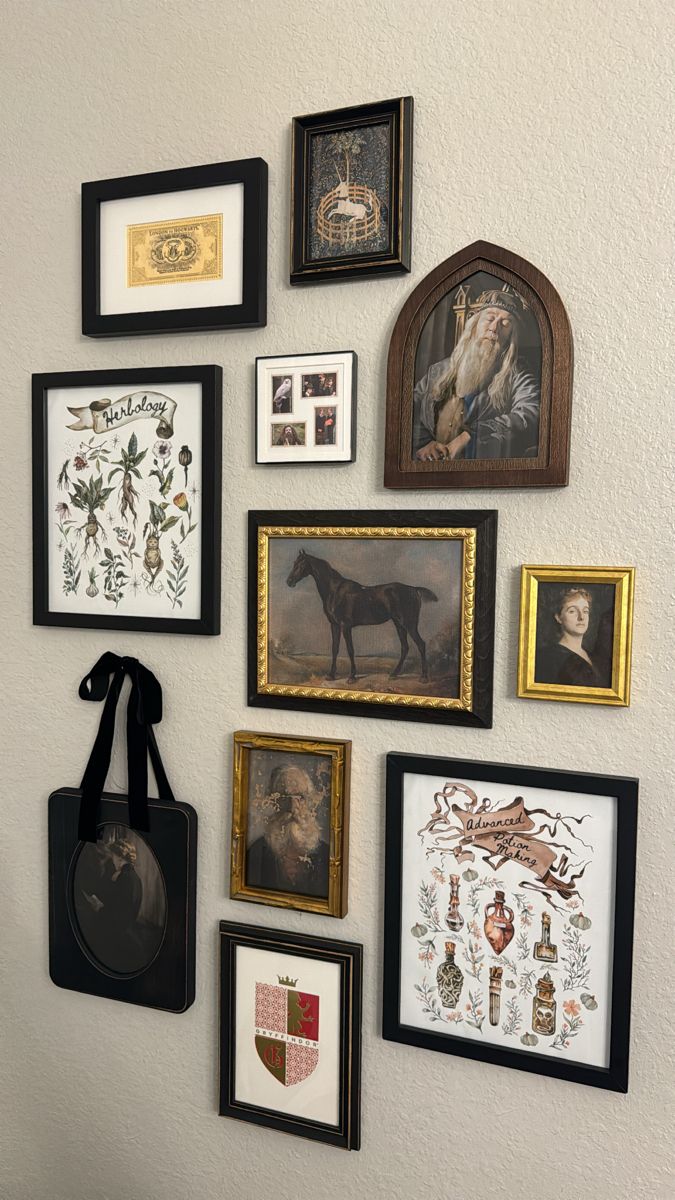 a wall with many framed pictures on it and a purse hanging from the wall next to it