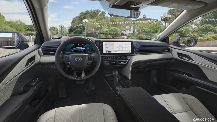 the interior of a car with dashboard, steering wheel and center console in front of it