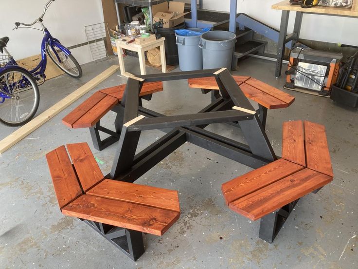 a wooden table and benches in a garage