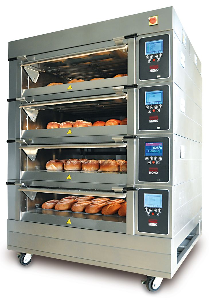 an oven with several trays of donuts in it