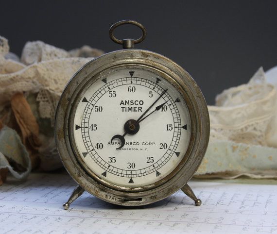 an old clock sitting on top of a piece of paper