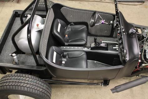 the inside of a car that is parked in a garage with no one around it