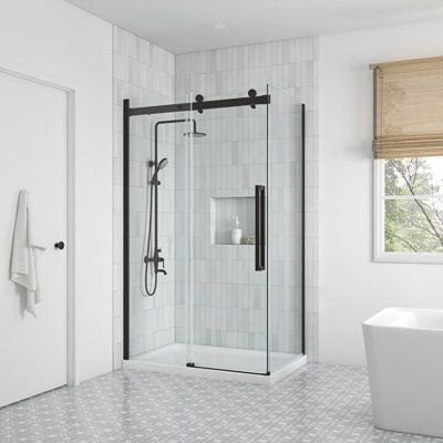 a bathroom with a tub, shower and window