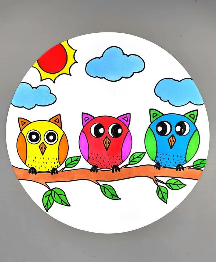 two colorful owls sitting on a tree branch