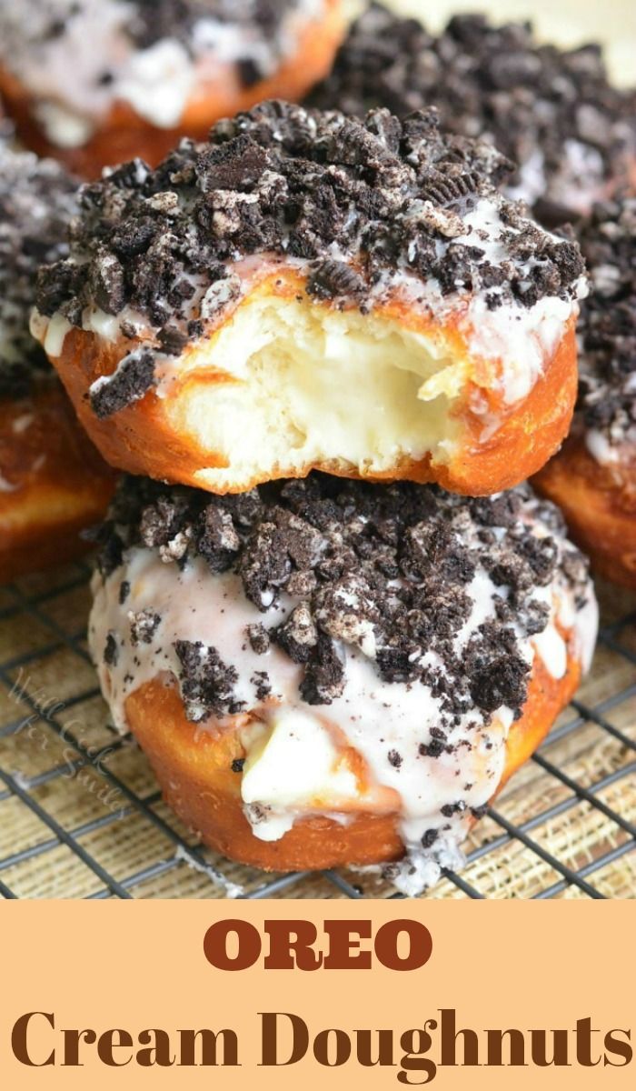 chocolate covered doughnuts sitting on top of a cooling rack