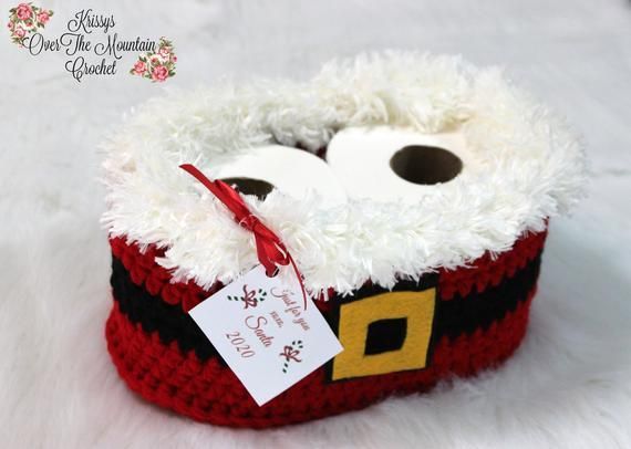 a crocheted santa hat with two googly eyes and a tag on it