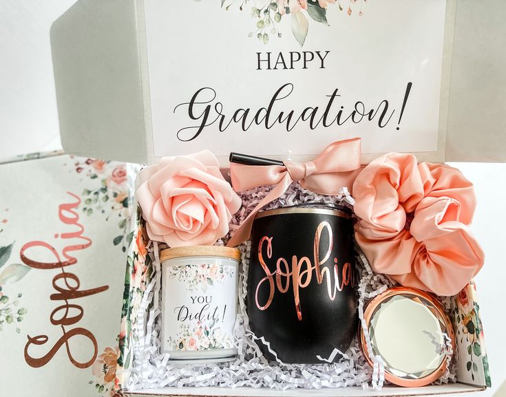 a graduation gift box with personalized items and a sign that says happy graduation on it