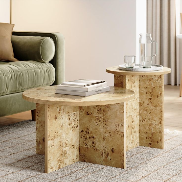 two tables sitting next to each other in front of a couch and table with books on it