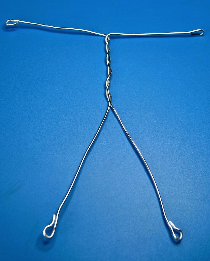 a pair of scissors that are on top of a blue surface with wires attached to it