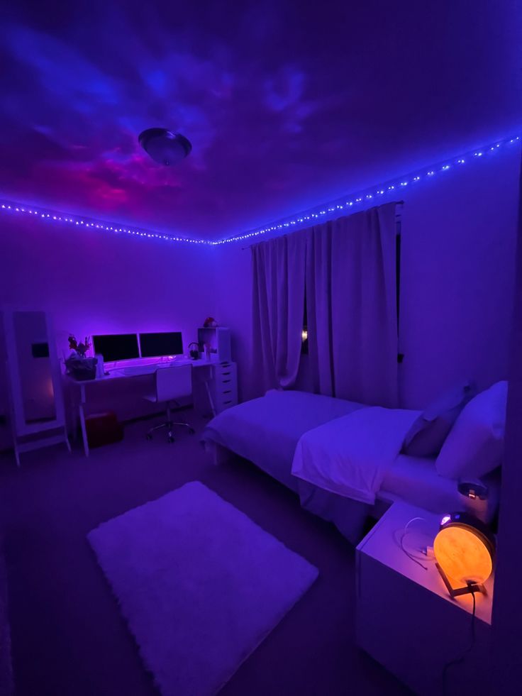 a bedroom with purple lighting and white furniture