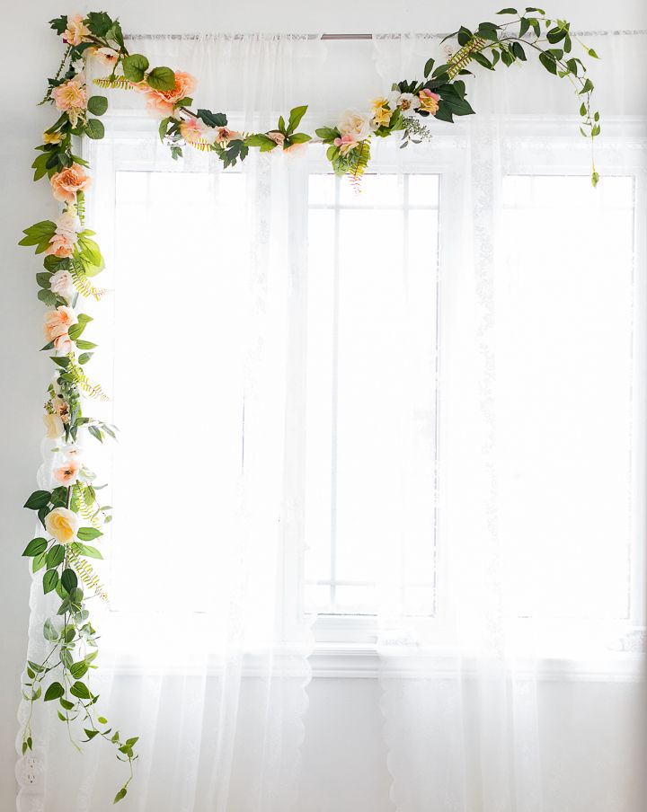 the curtains are covered with flowers and greenery in front of a white window sill