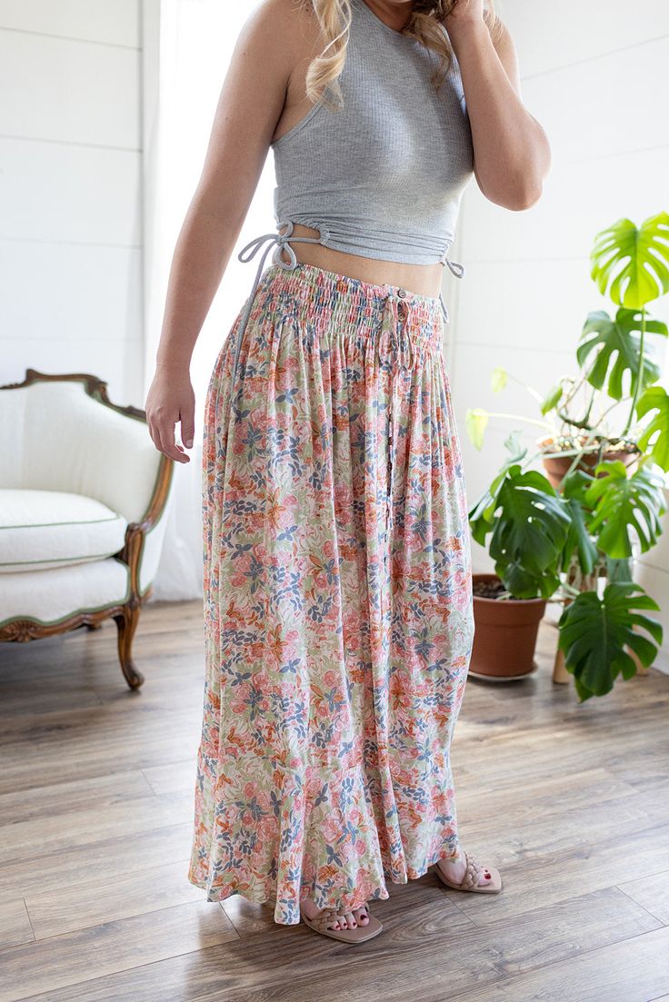 Look no further, our best-selling maxi skirt is here in a fresh new print! The stunning bright floral print, flattering button detail, and a flowy maxi-length is sure to make this your go-to for any summer get-together! Whether you’re heading out on a flirty date night or a daytime gathering, the only thing you’ll be worried about is having too much fun! Features: smocked elastic waist, functional buttons, lined to knee, floral print, open in front, long length Color: Blush Mix100% RayonFor full care instructions, please refer to the manufacturer's label. Fit: True to size.Length: Hits at the ankle on most -- 42” in total lengthWaist: Stretchy with elastic waistbandHips: Relaxed with give Models are wearing size Medium and Small respectively. MODEL INFO Ashley Brook Height: 5'3" Height: 5' Play Date, Floral Maxi Skirt, Color Blush, New Print, Floral Maxi, Button Detail, Long Length, Smocking, Date Night