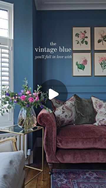 a living room with blue walls and furniture