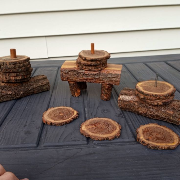 several pieces of wood sitting on top of a table next to small stools and logs