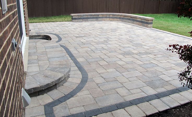 a brick patio with steps leading up to it