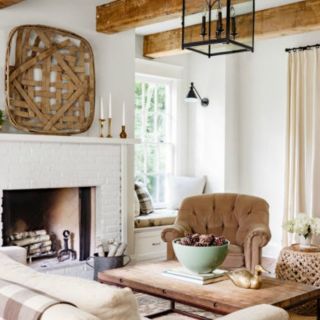 a living room filled with furniture and a fire place in front of a white fireplace