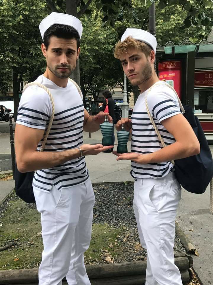 two men in sailor outfits standing next to each other